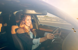 Smiling woman driving car