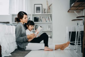 Mother sitting with young child in their home