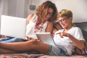 Mom with young son looking at his iPad.